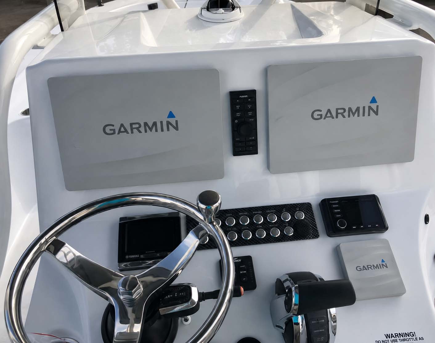 Dual Garmin chartplotters with Fusion stereo on center console